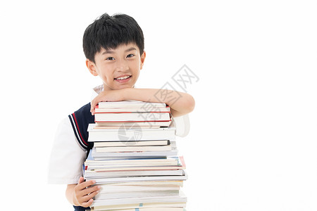 一摞书素材爱学习的小男孩抱着一摞书背景