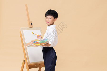 美术暑假班毛笔字手拿调色盘画画的小男孩背景
