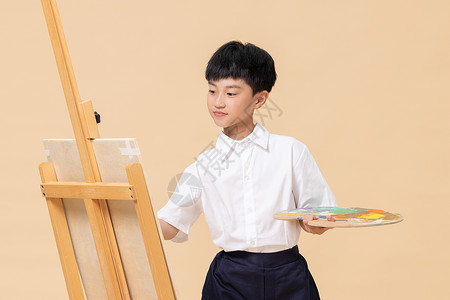 画油画的小男孩背景图片