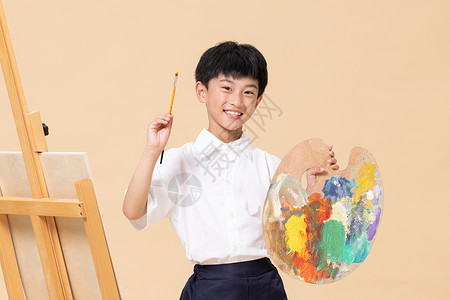 暑假招生暑期班手拿调色盘画画的小男孩背景