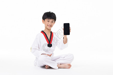 穿着跆拳道服的小男孩展示手机图片