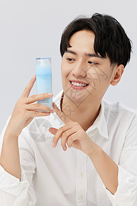 韩系男生手拿瓶装乳液图片