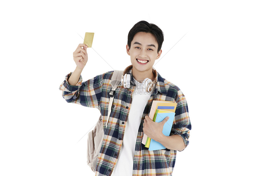 抱着书本和信用卡的男大学生图片