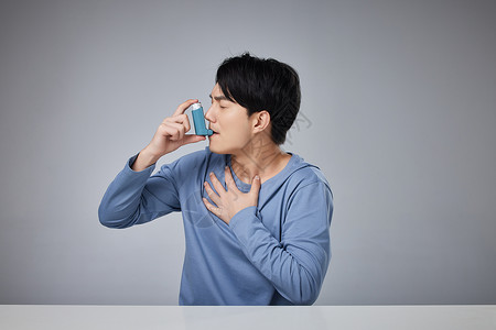 支气管哮喘年轻男性使用哮喘吸入器背景