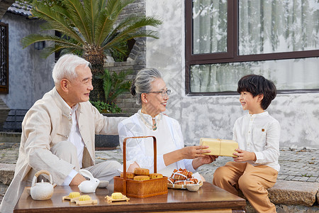 抬着月饼男孩中秋节孙子给爷爷奶奶送礼物背景