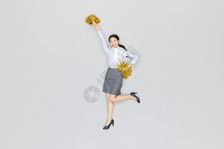 创意俯拍商务女性拿拉拉队手摇花加油背景图片