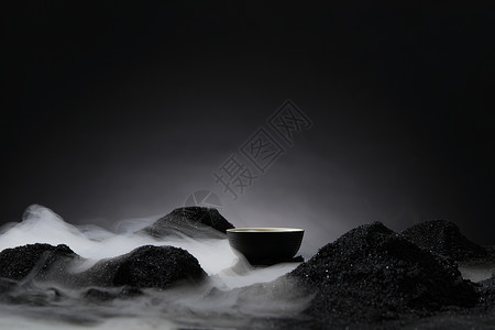 茶具冒烟黑色背景下的干冰和茶杯背景