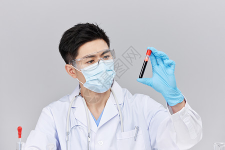 医疗科研男士观察研究试管里血液图片