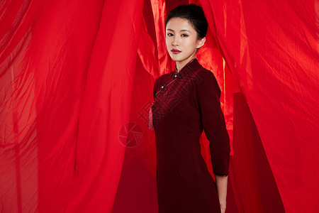 红色飘带背景中的旗袍美女背景图片