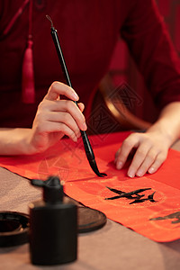 红桎木用毛笔写春联的旗袍美女背景