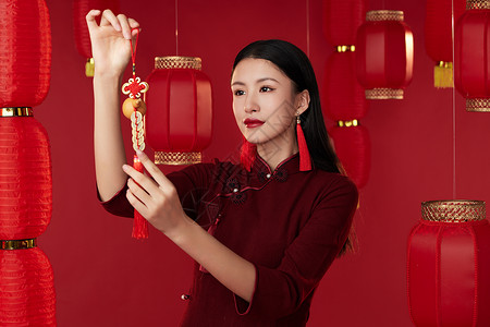 穿旗袍的年轻女子悬挂中国结图片