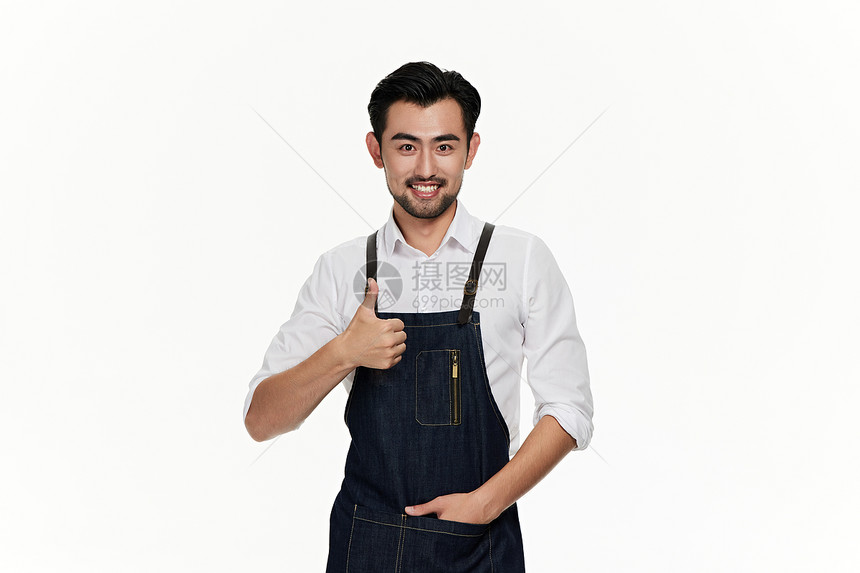 男性咖啡师插着围裙口袋竖大拇指图片