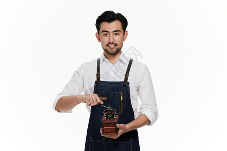 男性咖啡师拿着手摇磨粉机背景图片