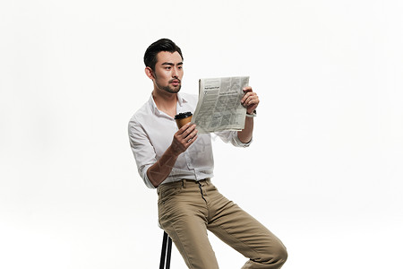 帅气的男人喝咖啡读报纸图片