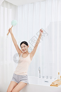 女性居家手拿浴球刷玩耍高清图片