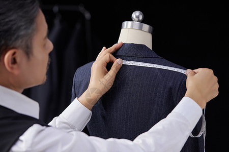 量体裁衣服装设计师测量西装肩宽特写背景