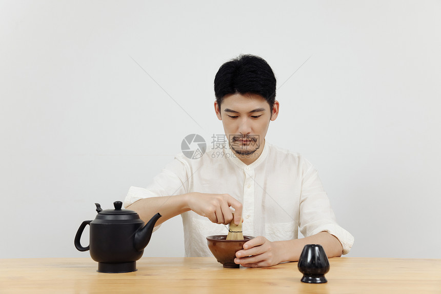 青年男性茶艺师使用茶筅筛茶图片