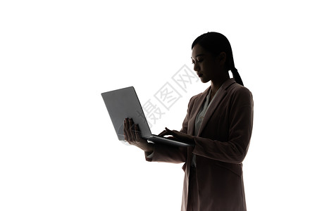 使用笔记本电脑办公的职场女性剪影图片