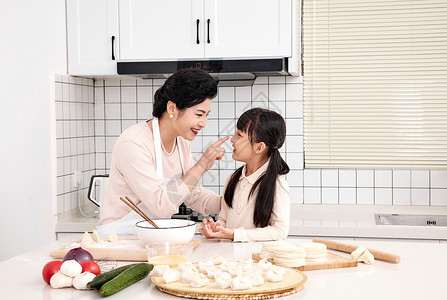 孩子与老人奶奶与孙女厨房里一起包饺子背景