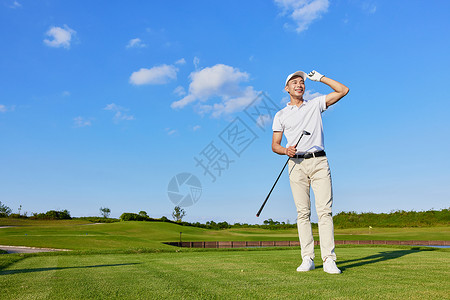 男性站在高尔夫球场看远方图片