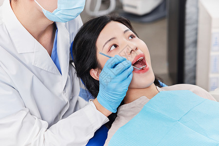 牙科医生为患者检查牙齿特写图片