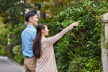 夫妻二人在高档小区里散步背景图片