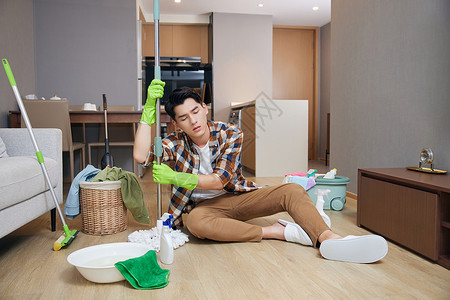 收拾家务的男人年轻男士做家务疲惫状态背景