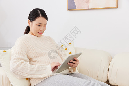 孕期妈妈居家坐沙发上看平板电脑图片