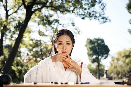 围棋古风户外品茶下围棋的古风汉服美女背景