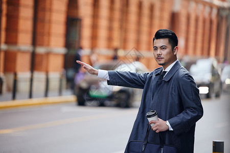 人挥手挥手拦车的冬季商务男士背景