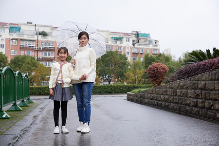 下雨天母女撑伞去学校背景图片