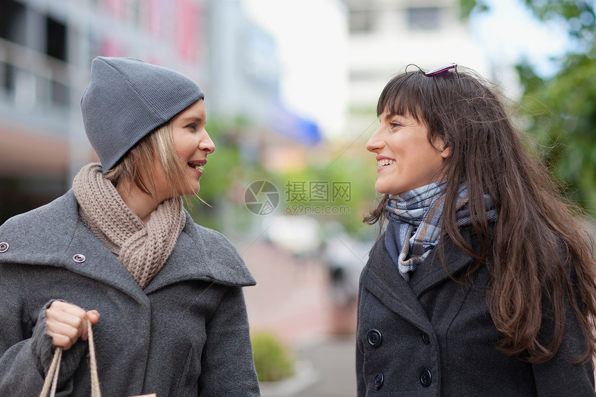 妇女在城市街上说话图片