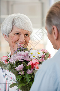 一位高级男子给妇女送花图片