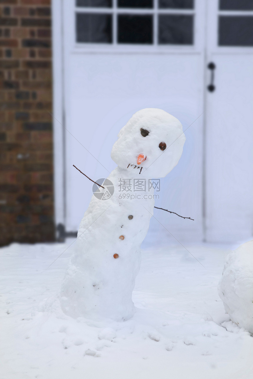 在车库门前倾斜的雪人图片