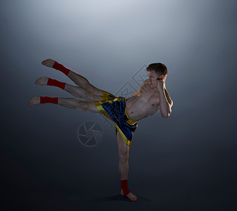 摄影棚拍摄的年轻男拳击手抬腿多次曝光图片