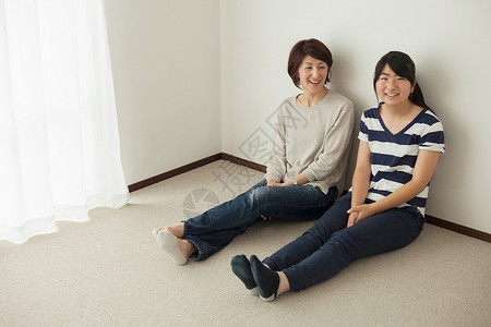 母亲和女儿坐在地板上肖像图片