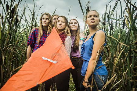 在沼泽中5名拿着风筝的年轻妇女肖像图片