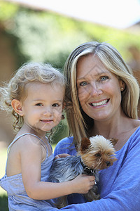 抱着年轻女儿和狗的妈妈图片