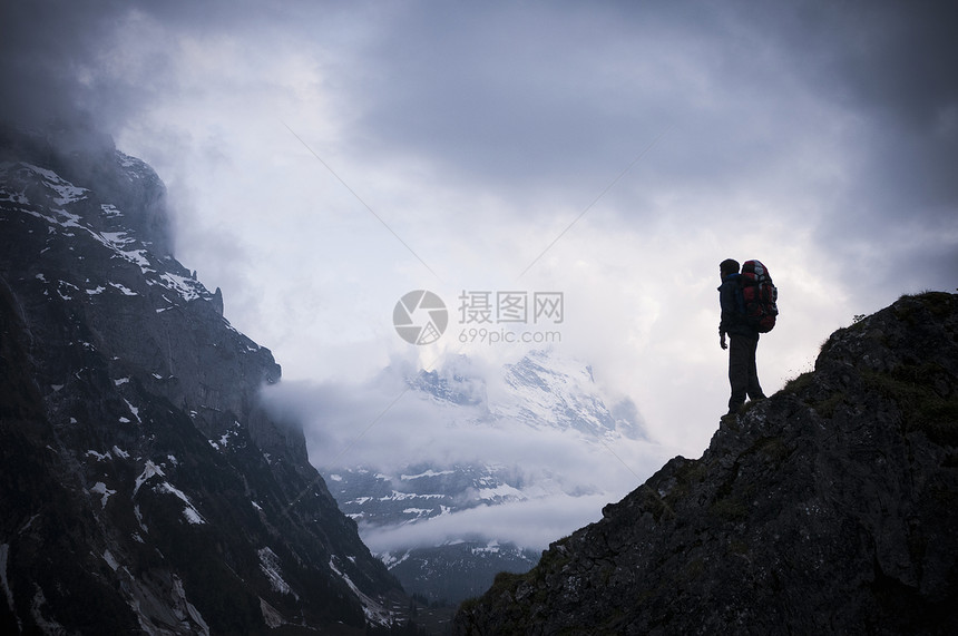 成功攀登山顶的背包客图片