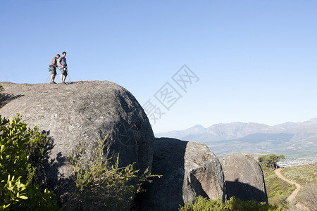 两名登山者站在山上图片