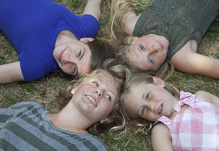 四个女孩躺在草地上背景图片