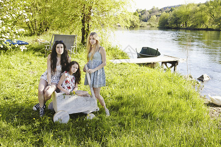 在湖边野餐的年轻妇女们肖像背景图片