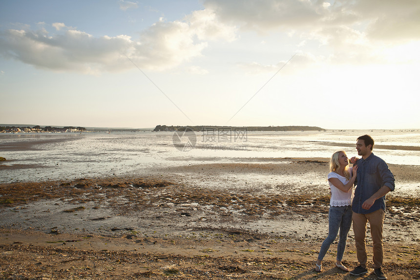 享受海滩风景的年轻夫妇图片
