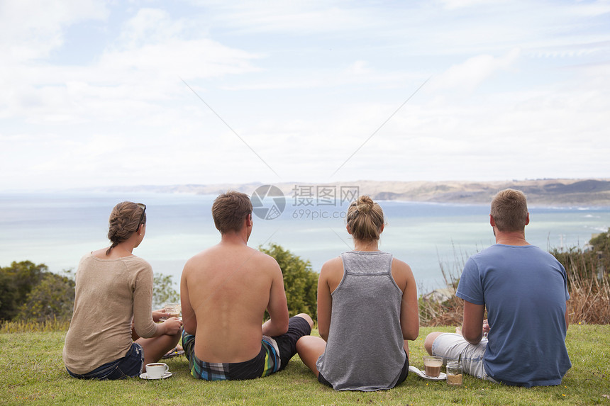 四个朋友坐远望海 图片