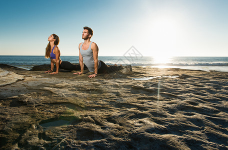 海滩上做瑜伽的情侣高清图片
