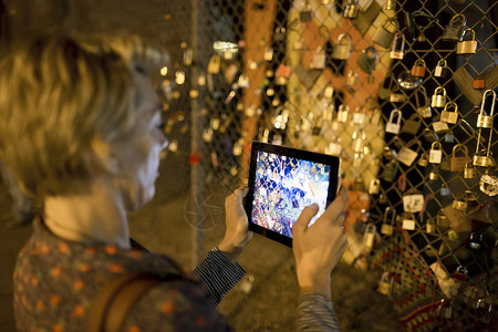 在英国伦敦的夜间墙上拍摄爱情锁图片