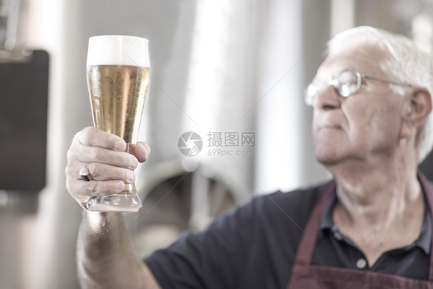 中年男子手举啤酒杯图片