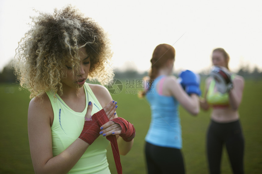 3名妇女在公园里用拳击手套进行运动图片