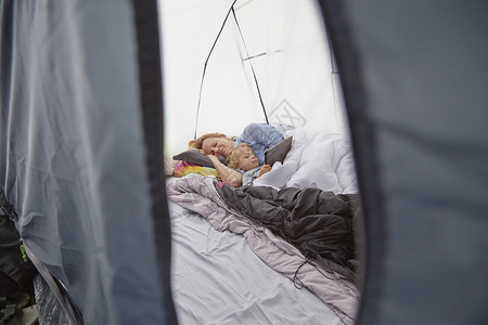 母亲和儿子一起躺在帐篷中的图片