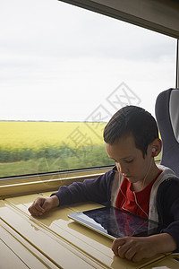 火车上男孩阅读数字平板电脑图片